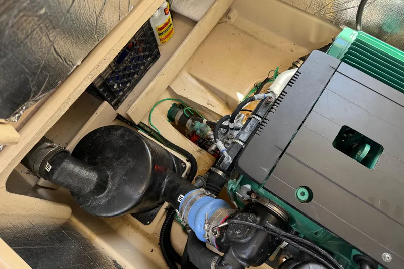 Slide: The Image of Engine compartment of a 2017 Ranger Tugs R-31 S, showcasing mechanical components and wiring. - 61