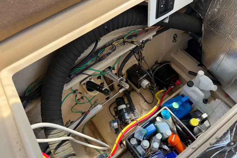 Slide: The Image of Engine compartment of 2017 Ranger Tugs R-31 S with wiring and maintenance supplies. - 65