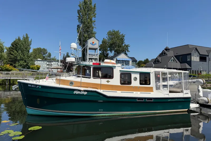 The Image of 2017 Ranger Tugs R-31 S boat docked in a scenic marina setting. - 0