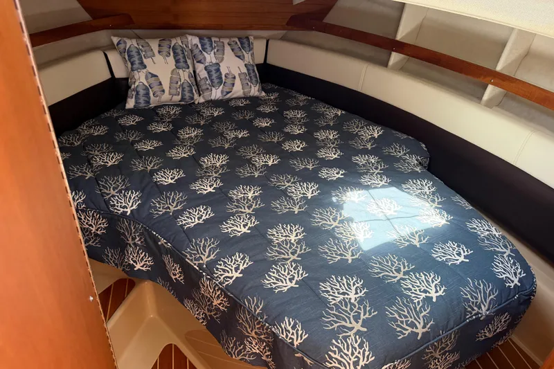 Slide: The Image of Cozy cabin interior of 2017 Ranger Tugs R-31 S with nautical-themed bedding. - 42