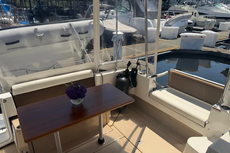 Slide: The Image of 2017 Ranger Tugs R-31 S boat interior with table and seating at marina. - 8