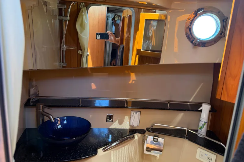 Slide: The Image of 2017 Ranger Tugs R-31 S bathroom with modern sink and porthole window. - 48