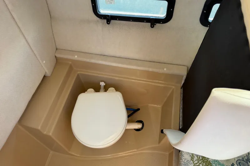 Slide: The Image of 2017 Ranger Tugs R-31 S interior bathroom with compact toilet setup. - 52