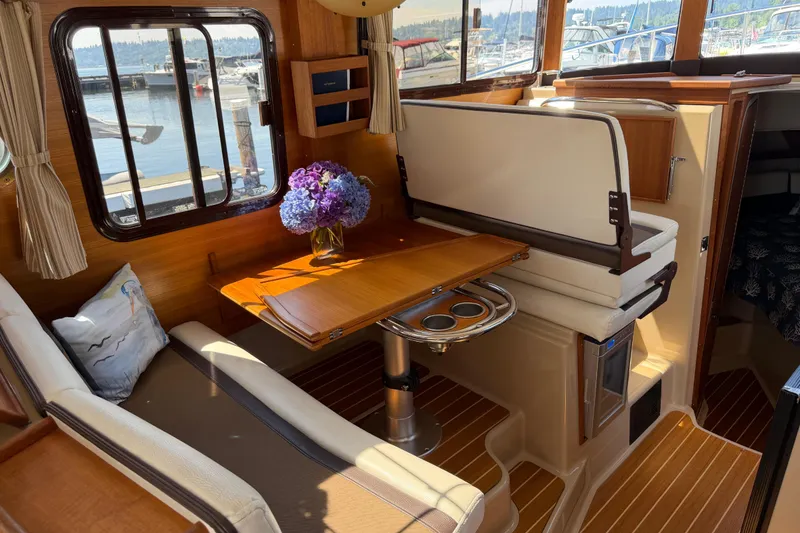 Slide: The Image of Interior of 2017 Ranger Tugs R-31 S with dining area and floral centerpiece. - 17