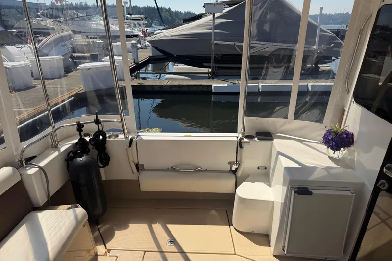 Slide: The Image of 2017 Ranger Tugs R-31 S boat interior with dock view and floral arrangement. - 3