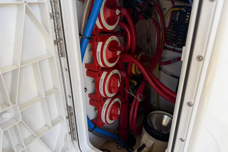 Slide: The Image of Engine compartment of 2017 Ranger Tugs R-31 S with red cables and switches. - 73