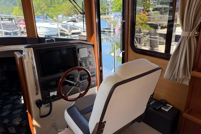 Slide: The Image of Interior helm of 2017 Ranger Tugs R-31 S with steering wheel and navigation equipment. - 26