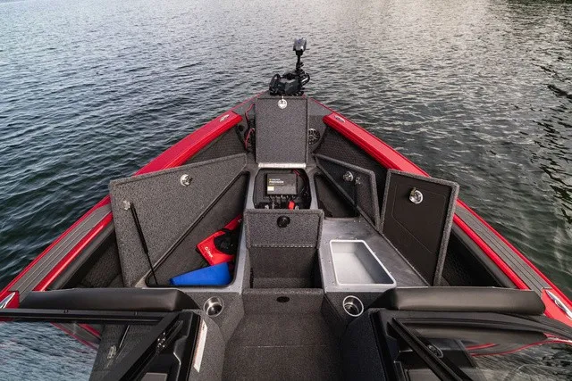 Slide: The Image of The image shows the cockpit of a 2027 Lund 2275 Tyee Sport boat with storage and equipment. - 13