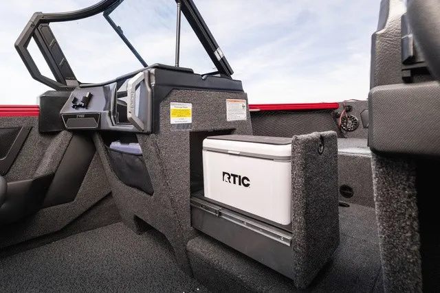 Slide: The Image of The image shows the cockpit of a Lund 2275 Tyee Sport boat with an RTIC cooler. - 4