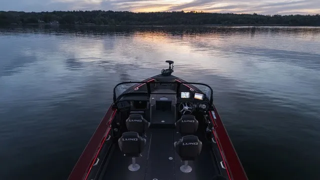 Slide: The Image of Lund 2275 Tyee Sport 2027 at sunset on calm waters. - 3