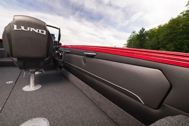 Slide: The Image of The image shows the interior of a Lund 2275 Tyee Sport boat with red accents. - 10