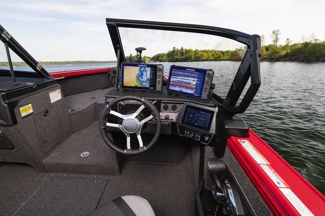 Slide: The Image of The image shows the cockpit of a Lund 2275 Tyee Sport boat with modern navigation systems. - 12