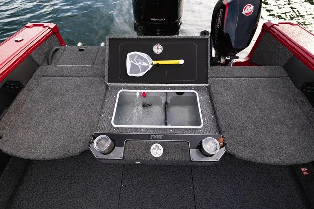 Slide: The Image of The image shows the stern of a Lund 2275 Tyee Sport boat with a motor and fish tank. - 6