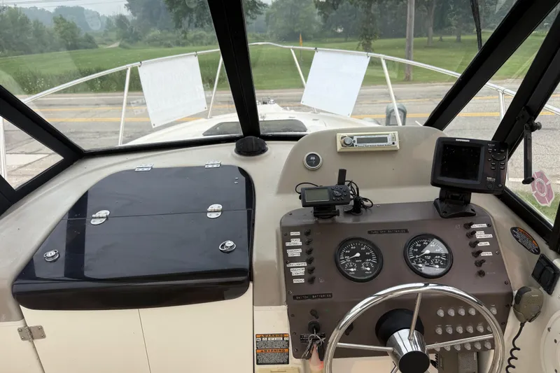 Slide: The Image of 2002 Bayliner 2052 Trophy Walkaround DX/LX boat dashboard with gauges and navigation equipment. - 6