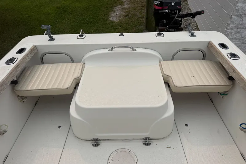 Slide: The Image of 2002 Bayliner 2052 Trophy Walkaround DX/LX boat interior with seating and fishing rod holders. - 4