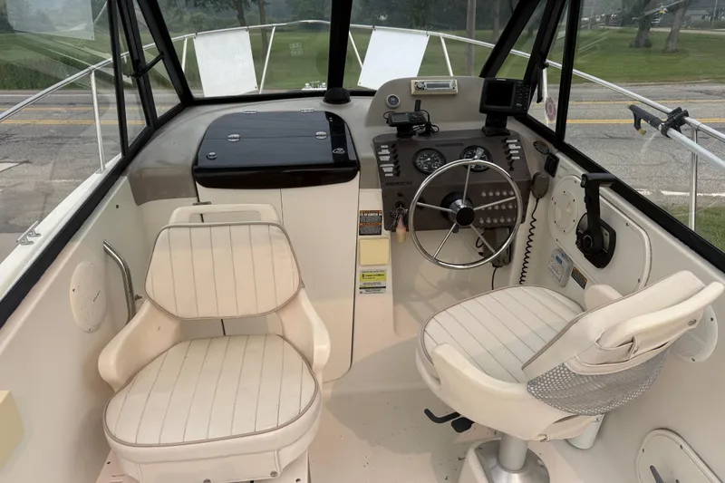 Slide: The Image of 2002 Bayliner 2052 Trophy Walkaround DX/LX boat cockpit with steering wheel and seating. - 5