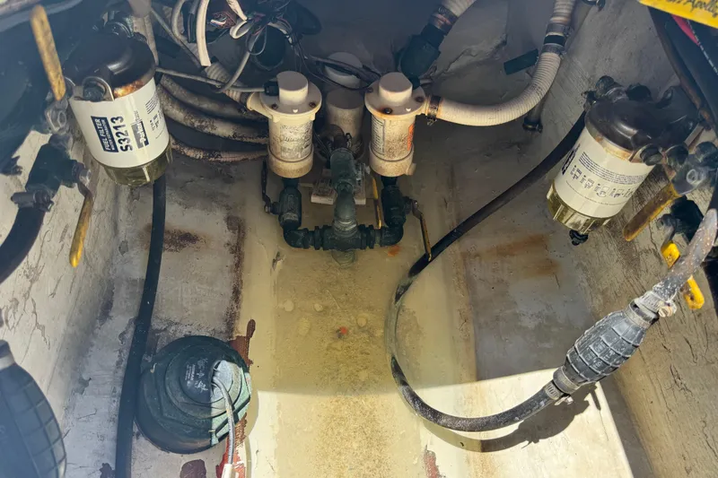 Slide: The Image of Engine compartment of a 2006 Contender 31 Open boat, showing fuel filters and hoses. - 27