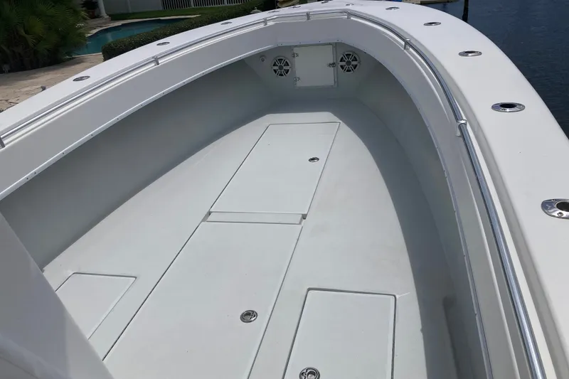 Slide: The Image of 2006 Contender 31 Open boat deck with storage compartments and sleek design. - 27