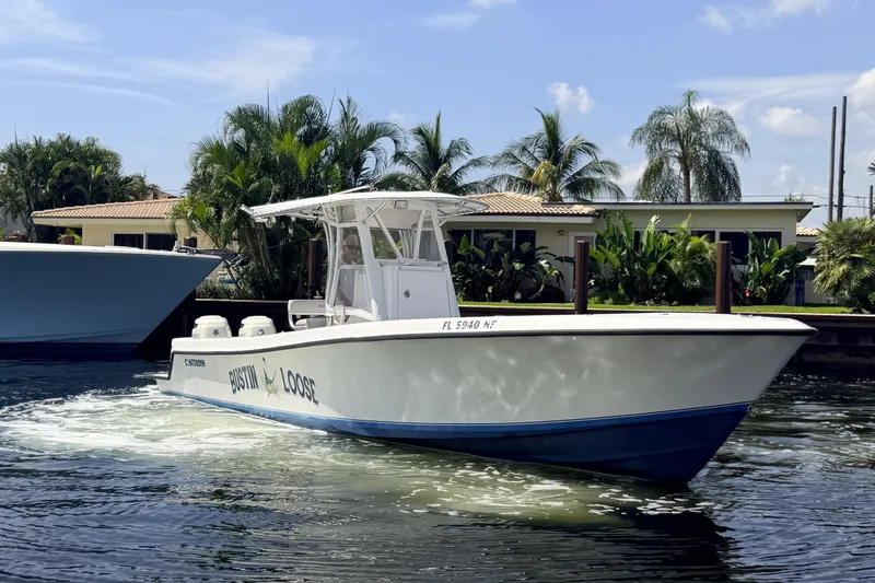 Slide: The Image of 2006 Contender 31 Open boat cruising on a sunny day near waterfront homes. - 7