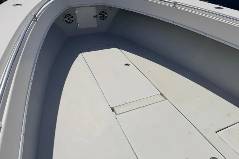 Slide: The Image of 2006 Contender 31 Open boat deck with storage compartments and speakers. - 28