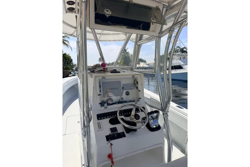Slide: The Image of 2006 Contender 31 Open boat helm with Garmin navigation system and steering wheel. - 18