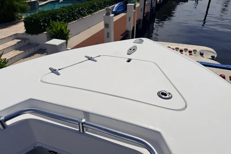 Slide: The Image of Bow of a 2006 Contender 31 Open boat docked by the water. - 31