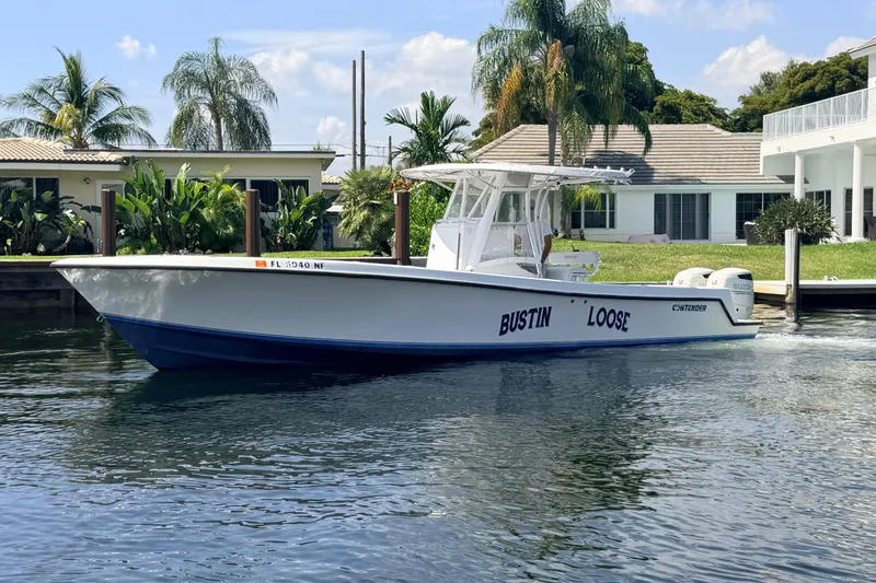The Image of 2006 Contender 31 Open boat named "Bustin' Loose" cruising on a sunny day. - 0