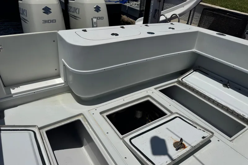 Slide: The Image of 2006 Contender 31 Open boat deck with storage compartments and Suzuki engines. - 25