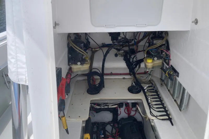 Slide: The Image of 2006 Contender 31 Open boat interior showing wiring and mechanical components. - 24
