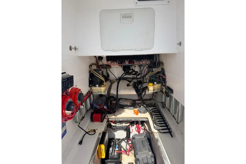 Slide: The Image of Electrical compartment of a 2006 Contender 31 Open boat, showing wiring and components. - 20