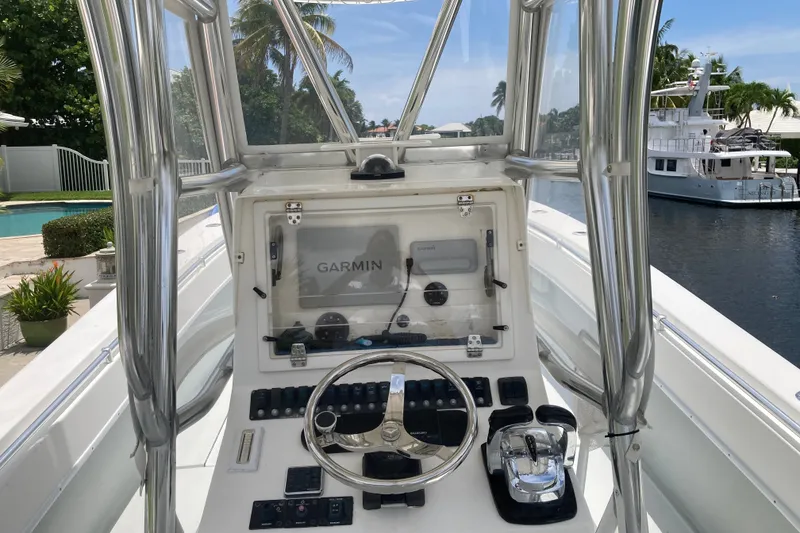 Slide: The Image of 2006 Contender 31 Open boat cockpit with Garmin navigation system, docked by a canal. - 20