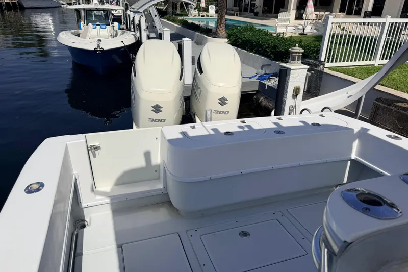 Slide: The Image of 2006 Contender 31 Open boat with twin Suzuki 300 engines docked by waterfront. - 30