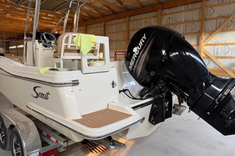 Slide: The Image of 2019 Scout 215 XSF boat with Mercury engine in a storage facility. - 5