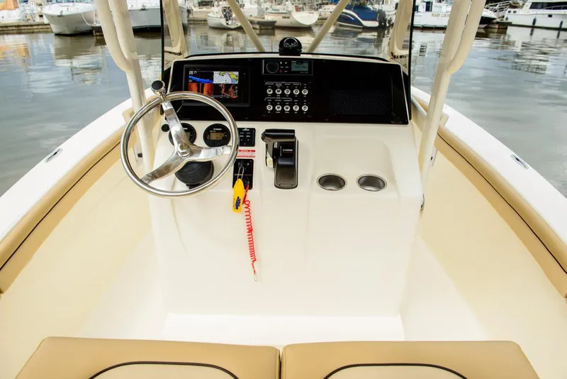 Slide: The Image of Manufacturer Provided Image: 2019 Scout 215 XSF boat console with steering wheel and navigation controls. - 13