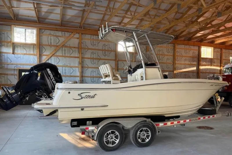 Slide: The Image of 2019 Scout 215 XSF boat on trailer in a wooden garage. - 1