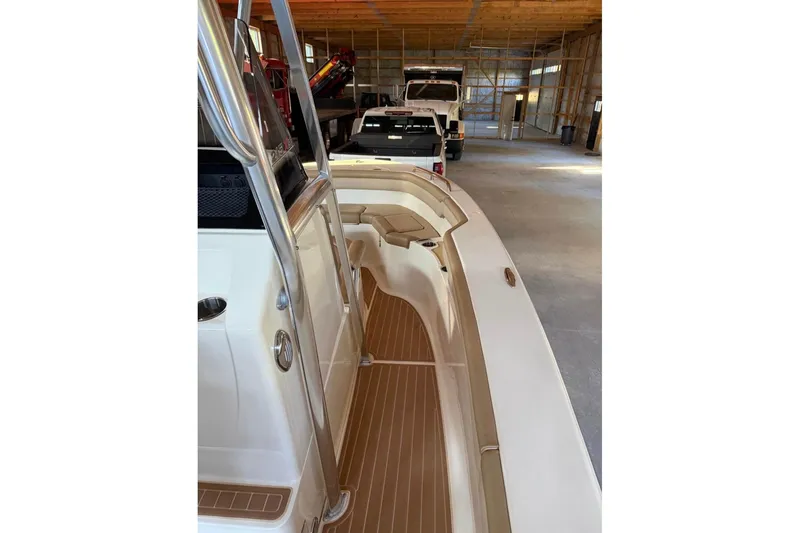 Slide: The Image of 2019 Scout 215 XSF boat in storage, showcasing sleek design and spacious interior. - 7