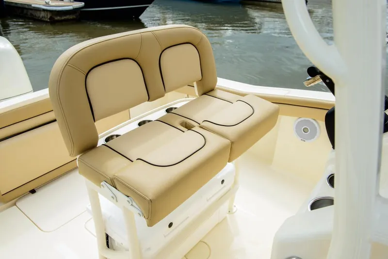 Slide: The Image of Manufacturer Provided Image: 2019 Scout 215 XSF boat with tan cushioned seating at the helm. - 16