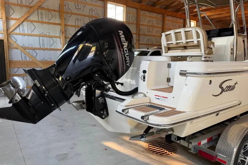Slide: The Image of 2019 Scout 215 XSF boat with Mercury outboard motor in a garage setting. - 4