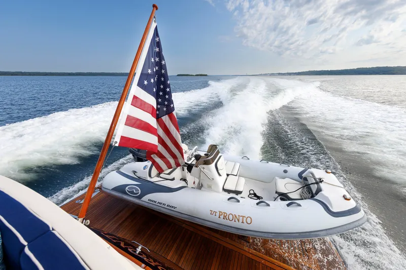Slide: The Image of Hunt Yachts 72 FB 2016 with American flag and inflatable boat on water. - 88