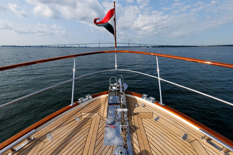 Slide: The Image of Bow view of 2016 Hunt Yachts 72 FB on open water, bridge in background. - 63