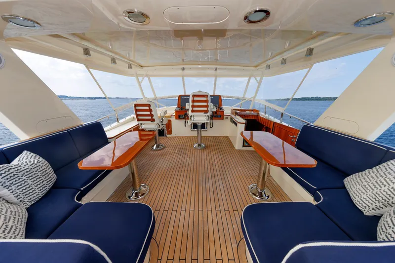 Slide: The Image of Luxurious 2016 Hunt Yachts 72 FB interior with elegant seating and wooden accents on open water. - 4