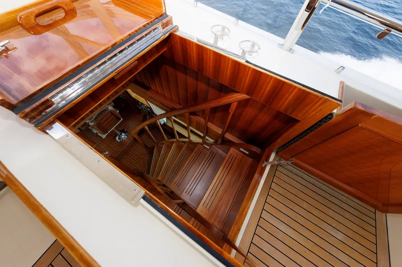 Slide: The Image of Staircase on 2016 Hunt Yachts 72 FB, showcasing elegant wooden interior design. - 56