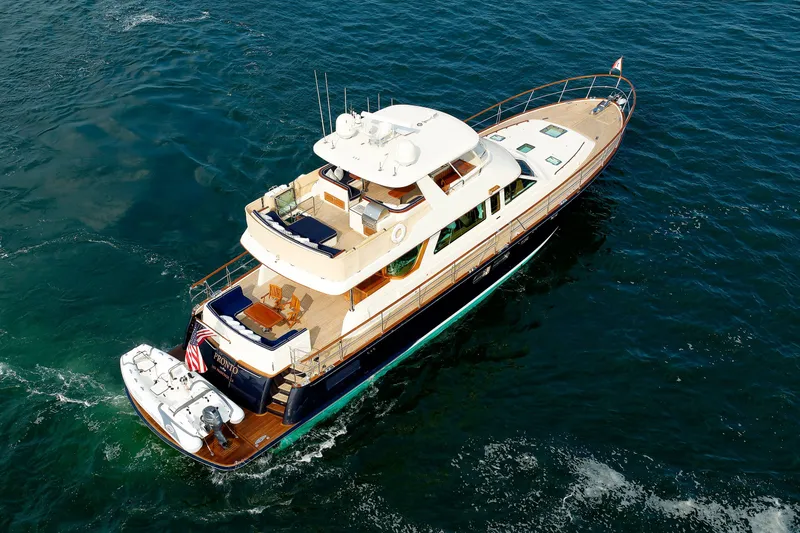 Slide: The Image of Luxury 2016 Hunt Yachts 72 FB cruising on open water, aerial view. - 79