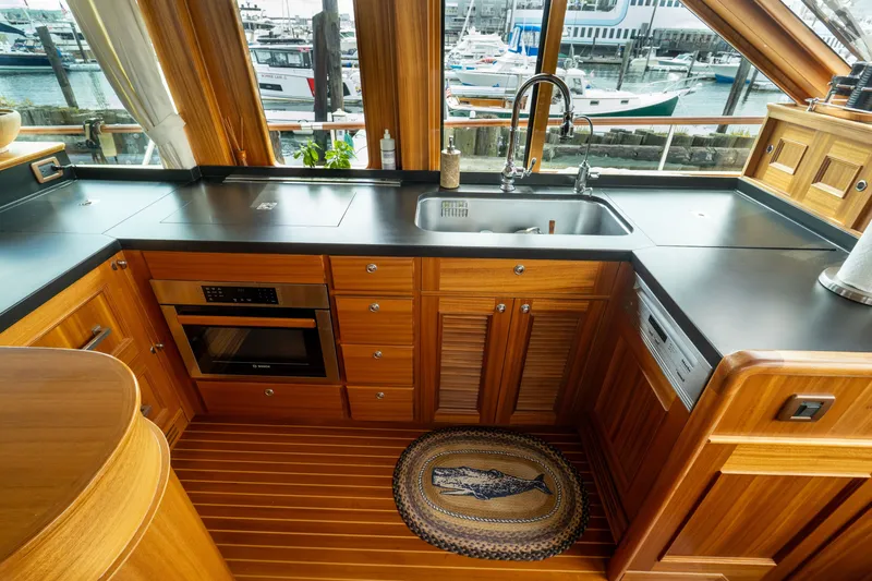 Slide: The Image of Luxurious kitchen interior of 2016 Hunt Yachts Ocean Series 72FB with wood cabinetry and modern appliances. - 17