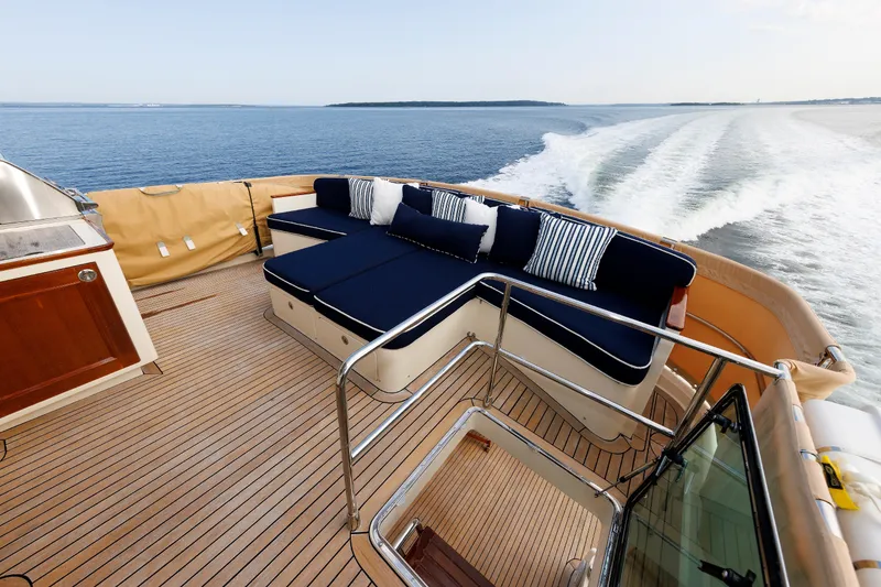 Slide: The Image of Luxurious 2016 Hunt Yachts 72 FB deck with elegant seating, cruising on open water. - 47
