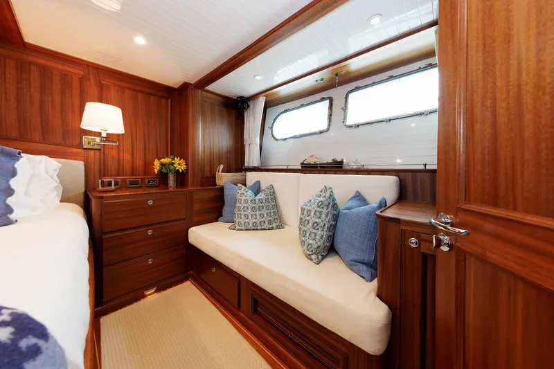 Slide: The Image of Luxurious 2016 Hunt Yachts 72 FB cabin interior with wood paneling and cozy seating. - 30