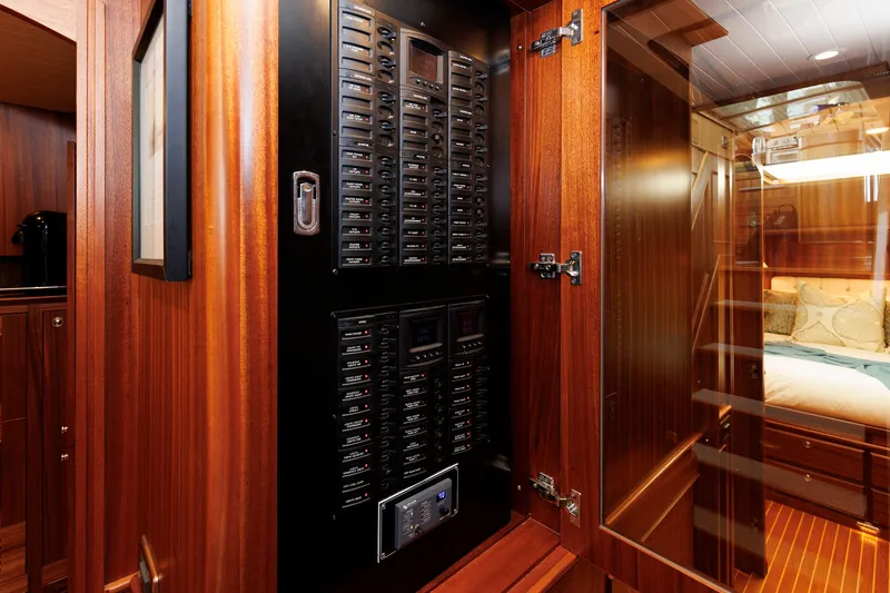 Slide: The Image of Electrical panel inside 2016 Hunt Yachts 72 FB, featuring luxurious wood interior. - 26