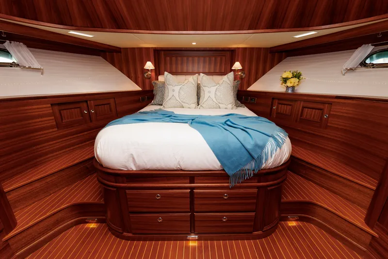 Slide: The Image of Luxurious cabin interior of 2016 Hunt Yachts 72 FB with elegant wood finish and cozy bedding. - 36