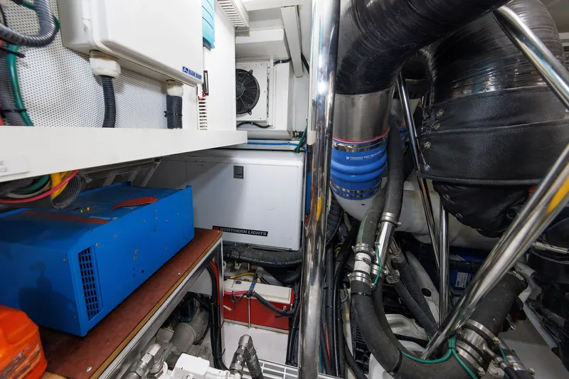 Slide: The Image of Engine room of 2016 Hunt Yachts 72 FB, showcasing mechanical components and equipment. - 73