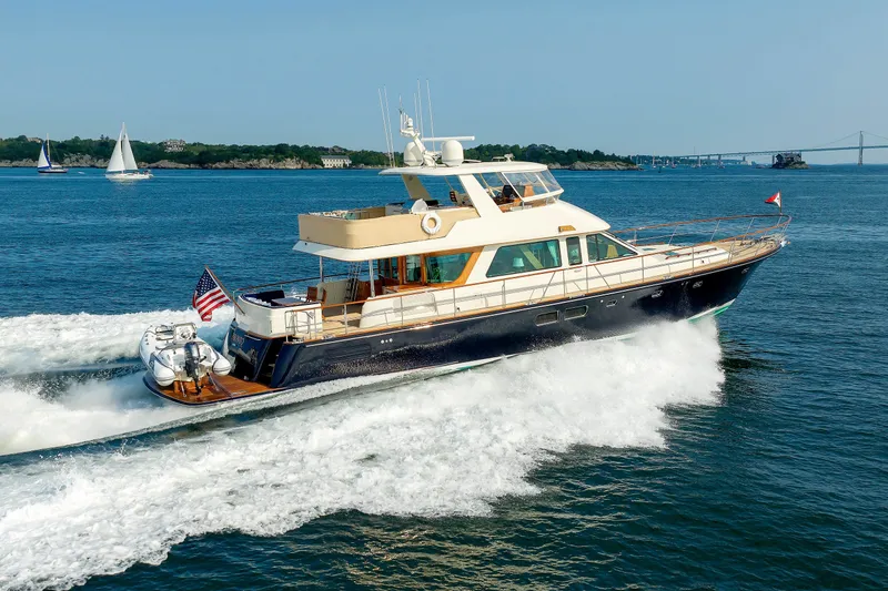 Slide: The Image of 2016 Hunt Yachts 72 FB cruising on open water with scenic background. - 81